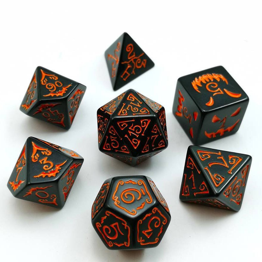 A set of seven polyhedral dice placed in an arrow on a white background. Black acrylic Filigree designs around numbers. The D6 has Halloween symbols in orange. Numbered with orange ink.