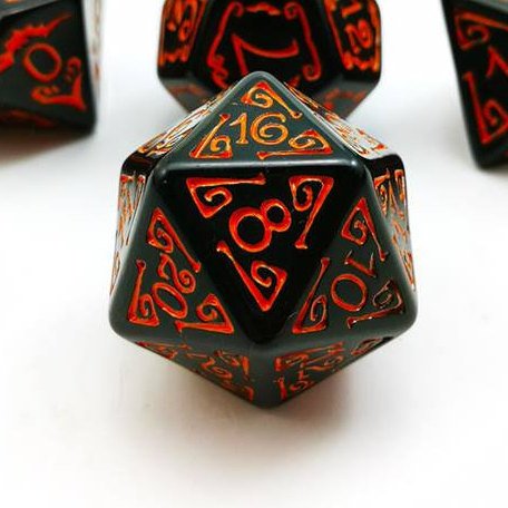 Black acrylic D20 dice with bright orange filigree designs around numbers, blurred similar dice behind sits on a white background.